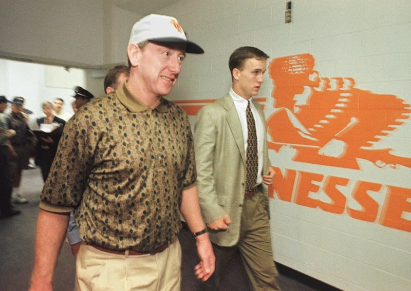 Peyton Manning (right) and his father Archie after a Tennessee game in 1997. (Photo credit: Wade Payne/AP)